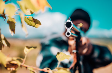 Hunting Licenses. Hunter with shotgun gun on hunt. Autumn hunting season. Poacher with Rifle Spotting Some Deers. Track down.の写真素材