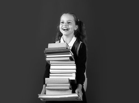 Happy teenage school child hold books green background, knowledge day.の写真素材