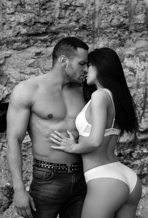 Sexy couple in love. Sensual boyfriend embraces lovers. The concept of tenderness and affection.の写真素材