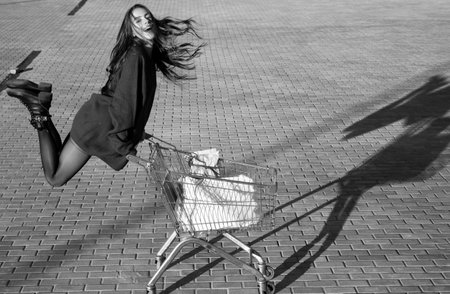 Marketing concept. Online shopping. Woman with shop cart.の写真素材