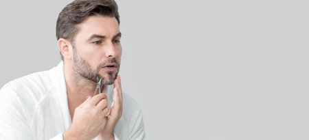 Cosmetic beauty products. Man advertising cosmetics cream for male skin care. Cream for male skin. Mens skincare. Banner for header, copy space. Poster for web design. Man advertising new cosmetic.の写真素材