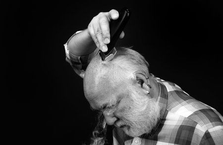 Senior hair clippings. Bald man hairclipper, Mature baldness and hair loss concept.
