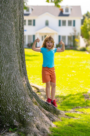 Little child play on summer backyard. Portrait of kid outdoors. Close-up face child playing outdoors in summer park.の写真素材