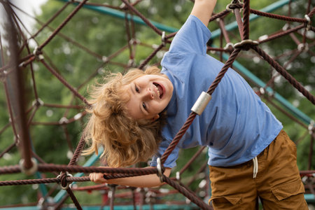 The outdoor playground for children in summer park. Kid play on playground under the tree. Portrait...