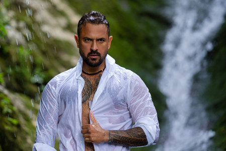 Sexy man on nature. Muscular male fit body. Strong athletic man. Fit male model. Healthy handsome Athletic Man outdoor. Guy showing muscular fit body. Sexy torso. Male flexing muscles.の写真素材