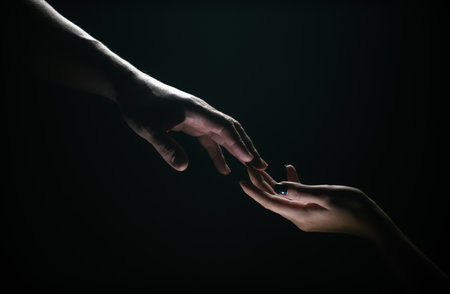 Two hands at the moment of farewell. Romantic touch with fingers, love. Help friend through a tough time. Rescue gesture, support, friendship and salvation concept. Man and woman holding hands.の写真素材