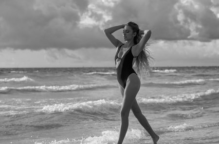 Maldives. Beautiful sexy woman in bikini lingerie swimwear on sea. Sexy girl with perfect body. Hot tanned female model on beach. Summer beach. Tanned girl in swimwear enjoying summer on beach.の写真素材