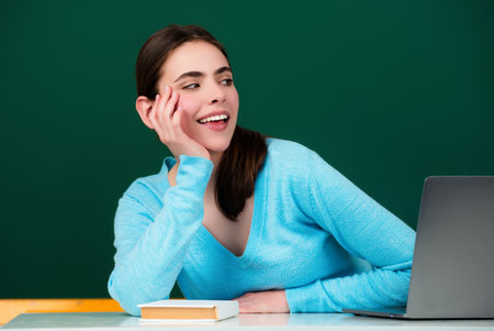 Student girl in classroom. Knowledge in College. Schoolgirl in high school. College student learning in college classroom. Education concept. Lesson and homework in College.の写真素材
