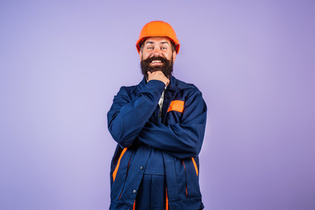 Worker in hardhat. Construction Worker with helmet. Worker in helmet at building. Portrait of Engineer Builder with Helmet. Worker from building site. Workers helmet and uniform.の写真素材