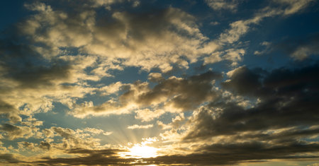 Sunset or sunrise. Dramatic majestic scenery sunset. Sky with clouds in sunset sky light background....