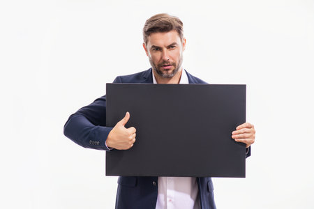 Good choice, recommend like concept with copy space. Man holds the black sign, blank card. Placard ready for your product. Sign to your text. Man showing thumbs up and blank sign board.の写真素材