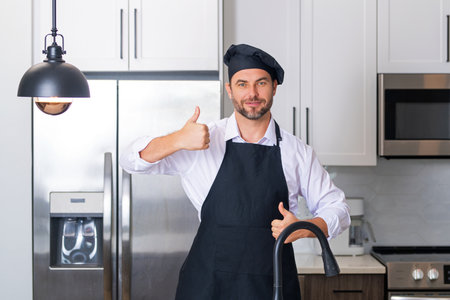 Man in chef apron cooking on kitchen.
