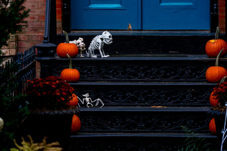 Decorated for Halloween with door. Halloween house outdoor decorations. Halloween pumpkin and skeleton for decorated house. Autumn holiday of Halloween.の写真素材