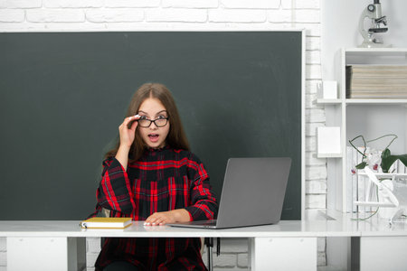 Portrait of school girl in classroom. School and students in classroom. Education kids. Child pupil...