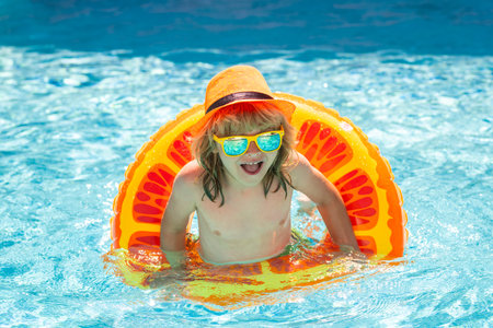 Young boy kid child splashing in swimming pool. Active healthy lifestyle, swim water sport activity...