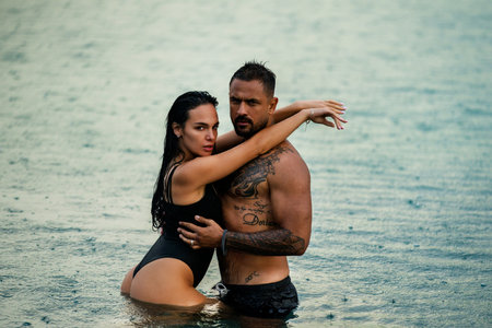 Romantic summer photo of sexy couple in the water. Romantic couple tender hug in the sea water. Sexy couple kissing by the sea. Romantic kiss. Dream summer vacation. Romantic love.の写真素材