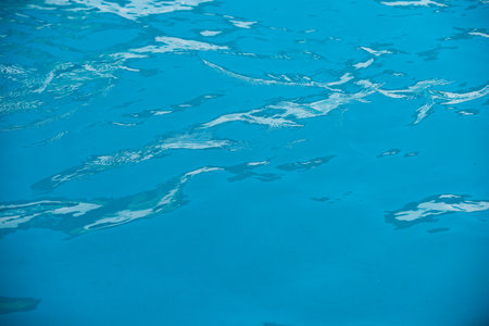 Pool water background, blue wave abstract or rippled water texture background.