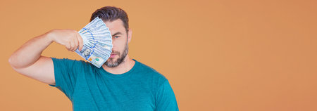 Man with money cash. 100 dollars banknotes. Portrait of man holding money. Dollar bills, credit,...