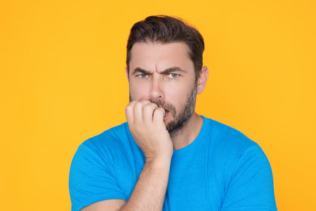 Man with hand on chin thinking about question, pensive expression. Thoughtful male face. Doubt...