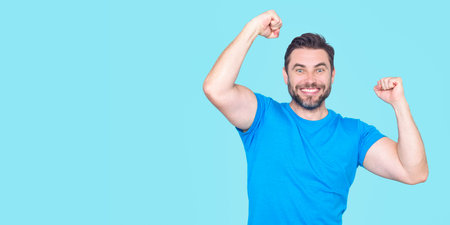 The winner. Successful man raising arms. Excited man with arms up celebrating success. Portrait of...