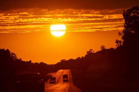 Big sun. Sunset sky dramatic sun clouds and sunset sunrays. Beautiful colorful dramatic sun with clouds at sunset or sunrise. Sun rays. Skyscape nature composition. Natural sky background.の写真素材