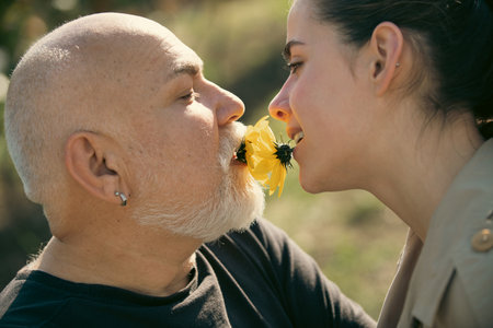 Senior old man and daughter hug and kiss. Lady with senior man, close up portrait. Senior grandad and young woman in love. Daughter and father kiss in love. Grandad and granddaughter. Parents love.の写真素材