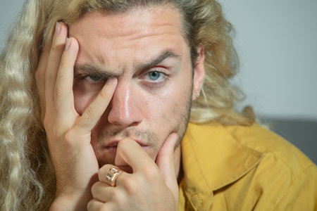 Worried Man with expression of anxiety. Stressed lonely Worried man feeling anxious. Worried Man experiencing mental health issues, worry, frustration, and emotional stress. Worried man feeling stress.の写真素材