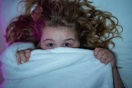 Child sleeping in a bed. Cute kid sleep. Kids pillow and blanket for sleeping. Kid sleeping in dark...