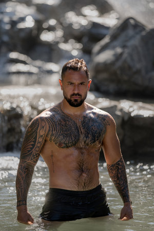 Muscular man. Rural guy. Body of strong farmer guy on countryside village. Six pack abs muscle. A muscular guy with a torso outdoor. Body of muscular guy outside.の写真素材