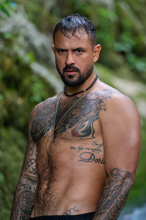 Man in morning splashing in water on nature. Hispanic man beauty face. Morning wellness. Good morning male face. Morning routine.の写真素材