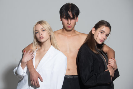 Threesome of man and two woman. Romantic relationships of Threesome. A group of models. Fashion people. Love and romance. Friends.の写真素材