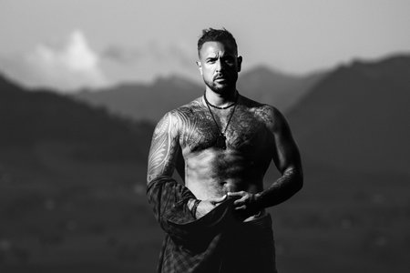 Muscular man body. Rural man. Body of strong man on countryside village. Six pack abs muscle. A muscular guy with a naked torso outdoor. Body of muscular man outside.の写真素材