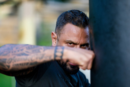 Boxer man with serious look, close up portrait. Serious male sport. Strong muscular male body,...