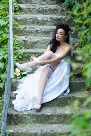A young bride in white wedding dress at a dream wedding. The bride looked beautiful on wedding day. A beauty bride, perfect wedding. Elegance young bride. The brides beauty.の写真素材