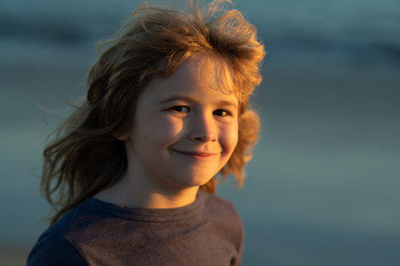 Kids dreaming face. Portrait of kid outdoors. Close-up face child playing outdoors in summer park.
