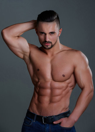 Topless man with muscle. Sexy male body. Handsome sexy model. Shirtless muscled male model. Man with a naked torso. Muscular young man with perfect body stripping. Sexy man. Seductive guy.の写真素材
