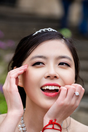 A sensual Asian bride in white wedding dress at a dream wedding. The bride looked beautiful on wedding day. A beauty bride, perfect wedding. Elegance young bride. The brides beauty.の写真素材