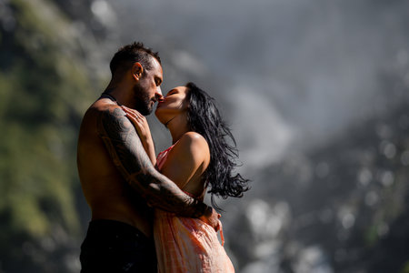 Couple in love embraced passionately on the nature. Couple kiss on nature. The romantic couple in love on summer nature. Outdoor portrait of sexy sensual couple. Tender kiss and passionate touching.の写真素材