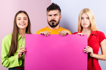 Group of friends showing board. Company people hold banner mockup, copy space. Team of 3 friends...