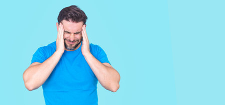 Stressed lonely man holding his head, feeling anxious. Man experiencing mental health issues worry frustration and emotional stress. Concept of anxiety and mental health. Worried man feeling stress.の写真素材