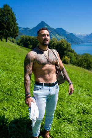 Sexy naked man with nude muscular body. Strong athletic shirtless man outdoor. Hispanic Fit male model. Healthy handsome Athletic Man. Muscular man outdoor. Guy showing muscular fit body.の写真素材