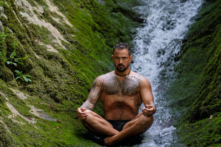 Man meditation. Sport model relax in nature. Meditation, spiritual wellness. Calm athlete meditation man training mindfulness. Relax and meditation in nature. Calmness and relax in nature.の写真素材