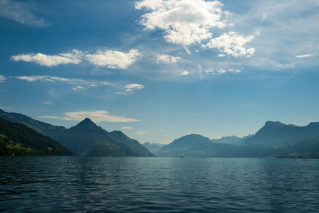 Lake in the Swiss Alps. Panoramic view of the nature and mountains of Switzerland. Mountain in the in summer, panoramic view with mountain. Alpine scenery. Mountains over the lake and the alps.の写真素材