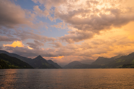 Lake in the Swiss Alps. Panoramic view of the nature and mountains of Switzerland. Mountain in the in summer, panoramic view with mountain. Alpine scenery. Mountains over the lake and the alps.の写真素材