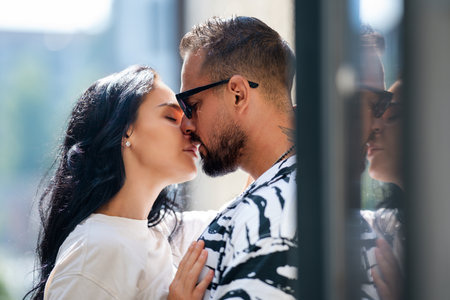 Romantic lovers kissing. Tender beautiful couple in love kissing. Lovely sexy couple kiss. Romantic kiss. Man kissing sensual woman. Romantic couple kissing at the date. Outdoor sensual kiss.の写真素材