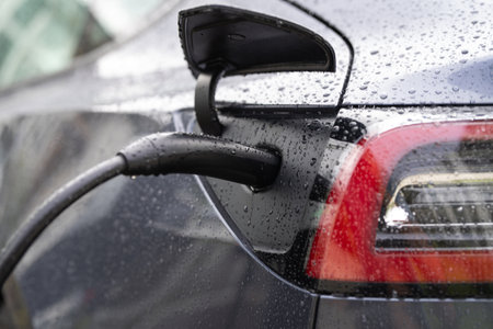 Electric car charger with cable. Electric car at a charging station. Plug for vehicle with electric...