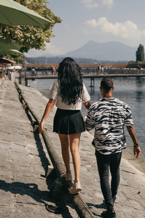 Sexy couple in love. Sensual woman and sexy man walking outdoor. Beauty couple passionately embracing in street. Sexy couple. Lovely couple walk in city. Sensual couples. Loving embrace. Sexy models.の写真素材