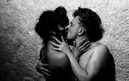 Romantic lovers. Tender beautiful couple in love. Romantic kiss. Man hugging sensual woman. Sexy couple. Couple kissing at the date.の写真素材