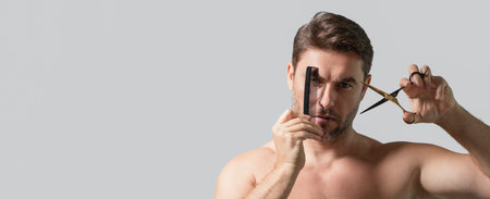 Mens hairstyle, haircut. Male hispanic model with scissors cut hair. Mens haircare, beauty barber concept. Bearded man, with scissors. Banner for header, copy space. Poster for web design.の写真素材