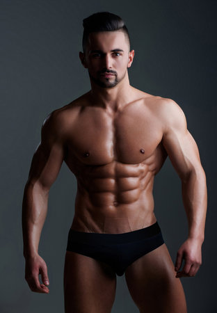 Topless man with muscle. Sexy male body. Handsome sexy model. Shirtless muscled male model. Man with a naked torso. Muscular young man with perfect body stripping. Sexy man. Seductive guy.の写真素材